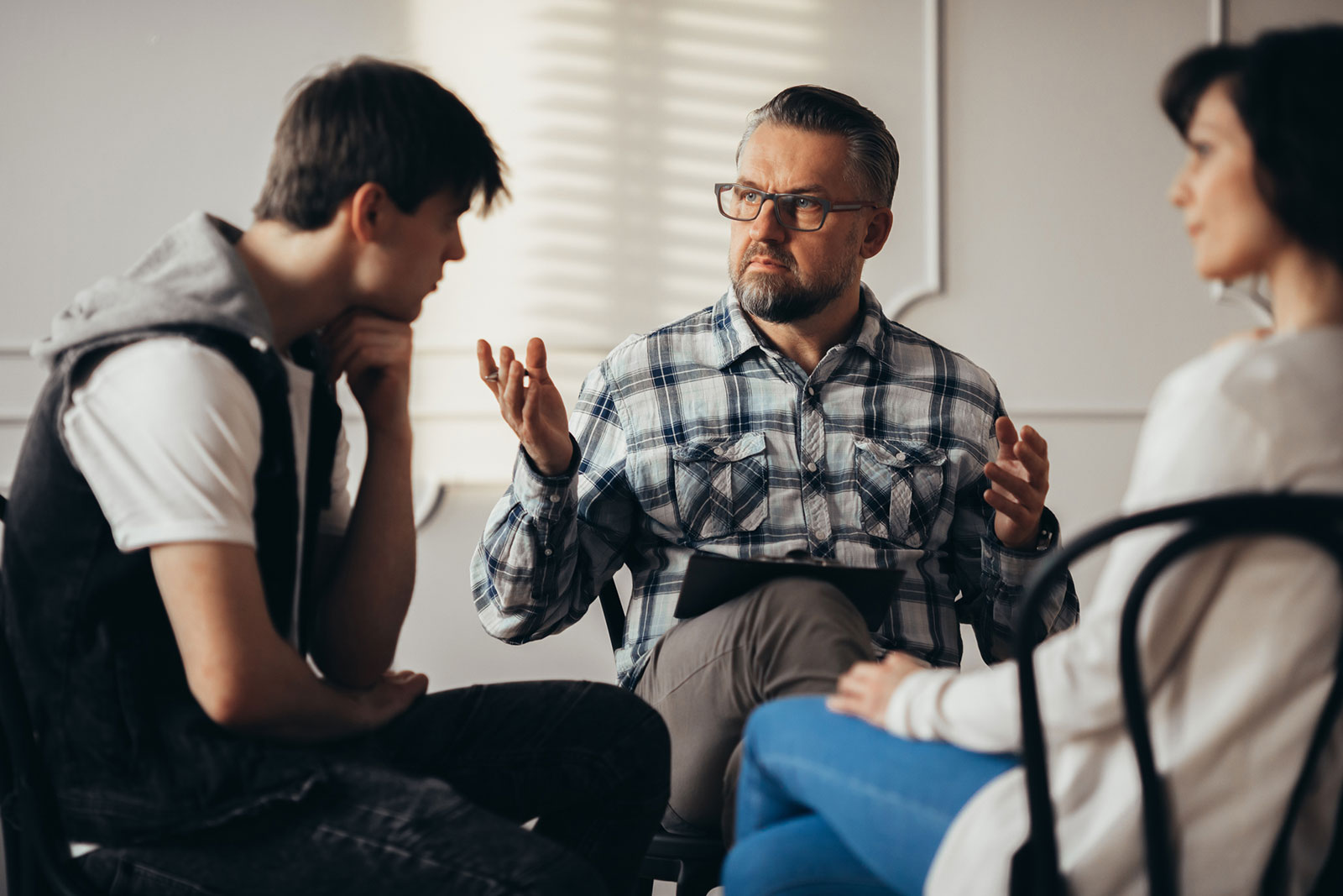 teenager and his mum during addiction therapy session