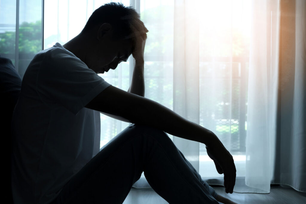 man sitting in the corner of the room has emotional and mental problems He has depression and anxiety