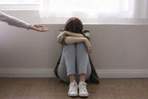 Girl crying seated on floor