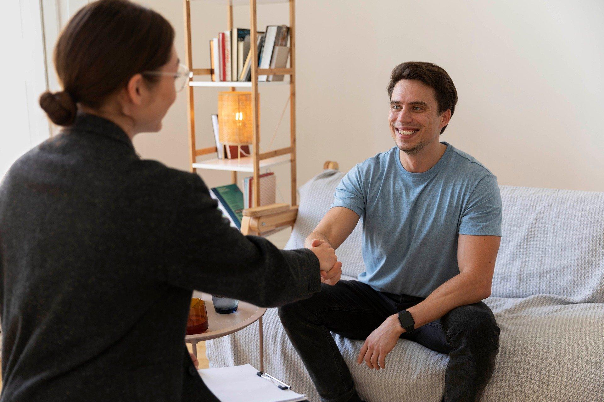 Therapist shakes a client's hand after a successful mental health treatment session
