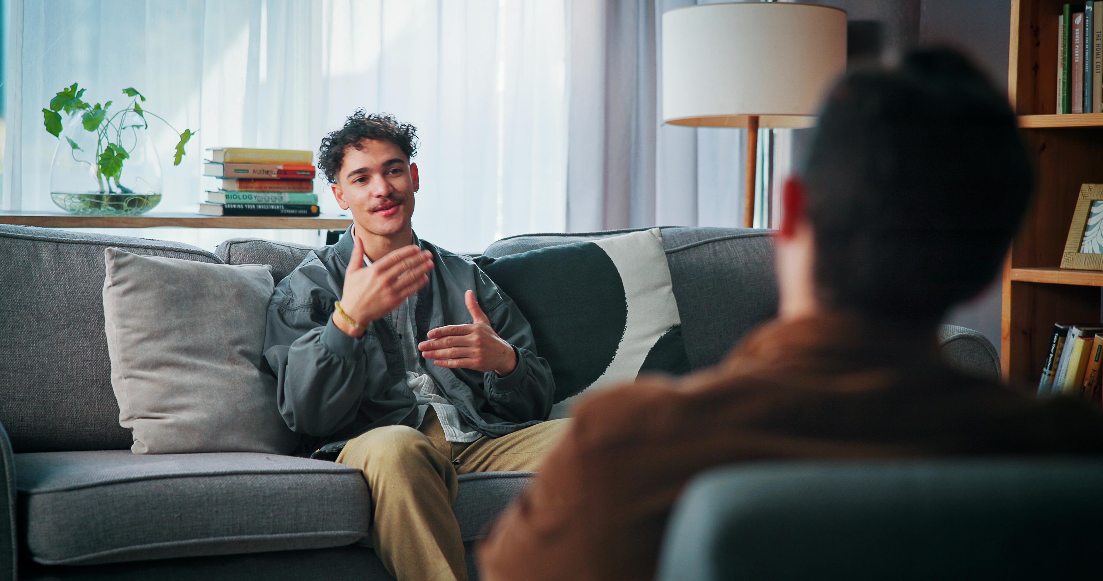 A therapist talks to his client, assessing the appropriate level of mental health treatment